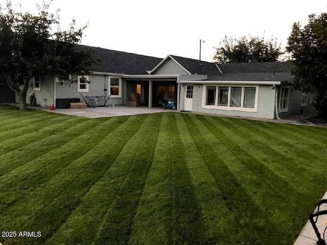 back of house featuring a patio and a lawn