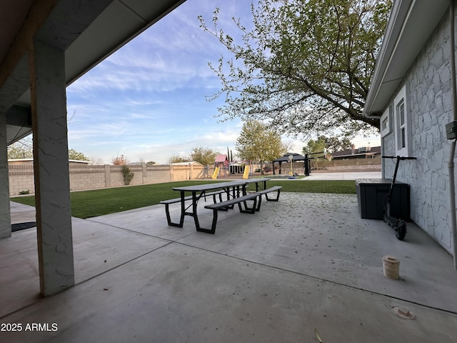 view of patio with fence and playground community