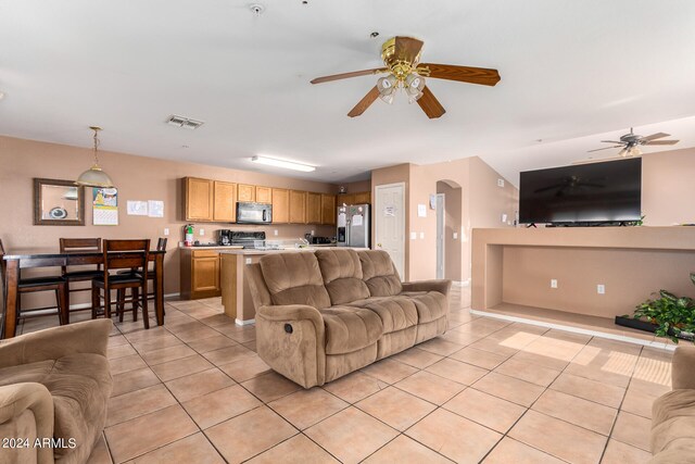 tiled living room with ceiling fan