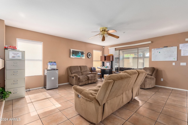 tiled living room with ceiling fan