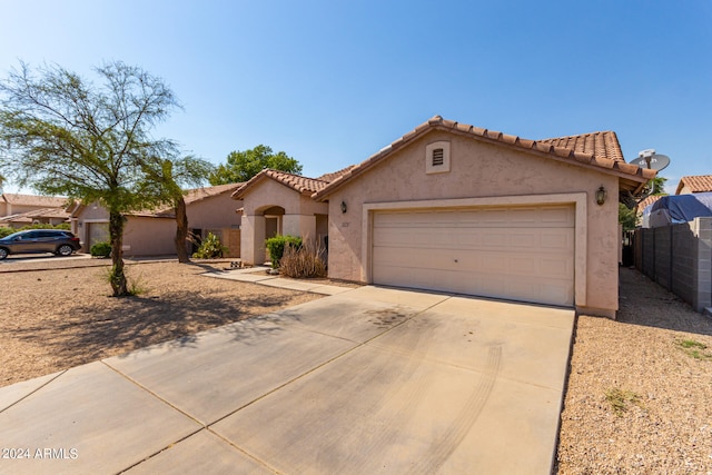 mediterranean / spanish-style home featuring a garage