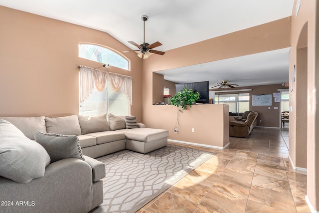 living room with tile patterned flooring, vaulted ceiling, and ceiling fan