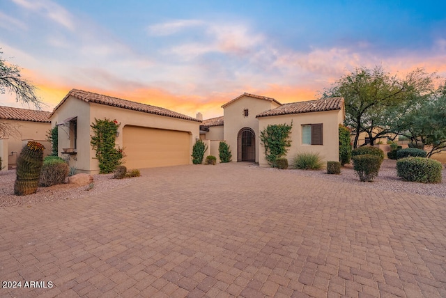 mediterranean / spanish house with a garage