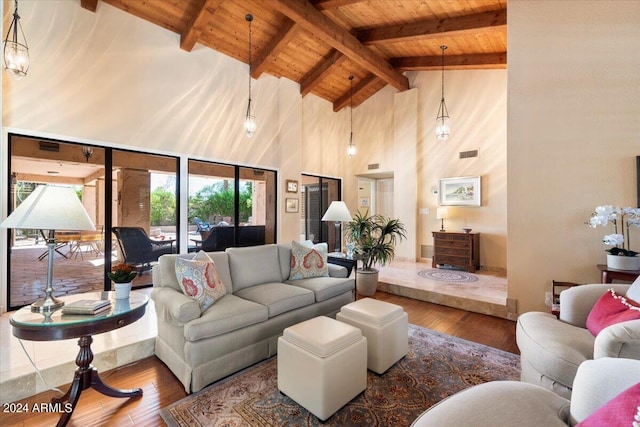 living room with high vaulted ceiling, wood ceiling, beam ceiling, and hardwood / wood-style floors