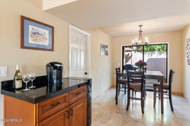 dining area with an inviting chandelier