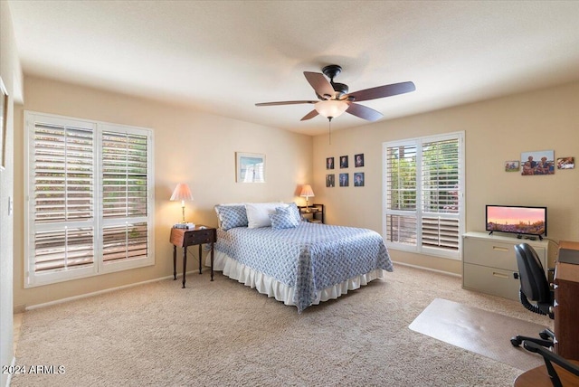 bedroom featuring ceiling fan and light carpet