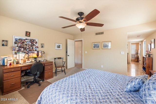 bedroom featuring light carpet and ceiling fan