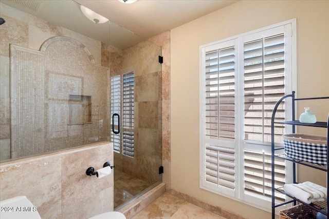 bathroom with tile patterned floors and a shower with shower door