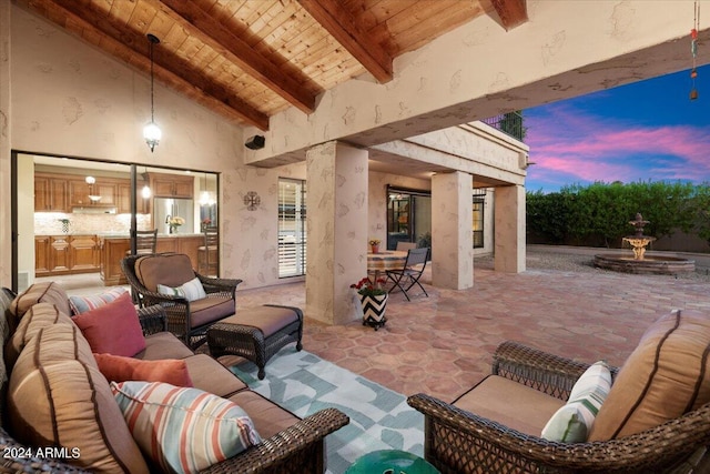 patio terrace at dusk featuring an outdoor hangout area