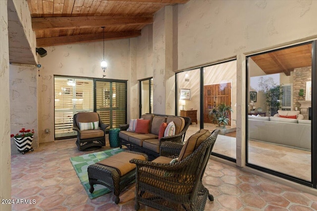 interior space featuring wood ceiling, beamed ceiling, and a healthy amount of sunlight