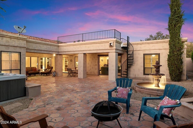 patio terrace at dusk with an outdoor fire pit