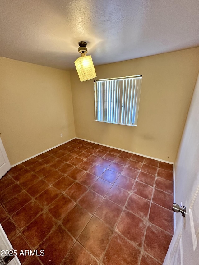 3211 W Campbell Ave, Phoenix, AZ 85017 - unfurnished room featuring a textured ceiling and dark tile patterned floors