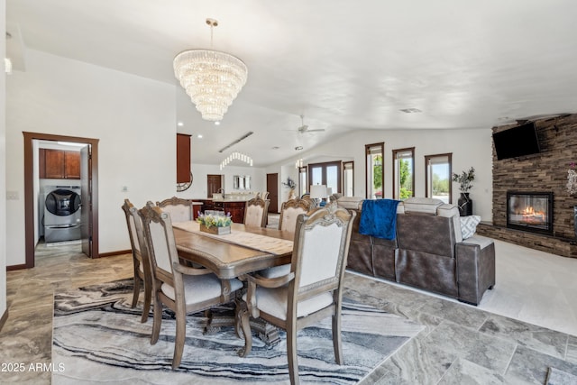 920 N 104th St, Mesa, AZ 85207 - dining space with washer / dryer, a chandelier, a fireplace, a ceiling fan, and lofted ceiling