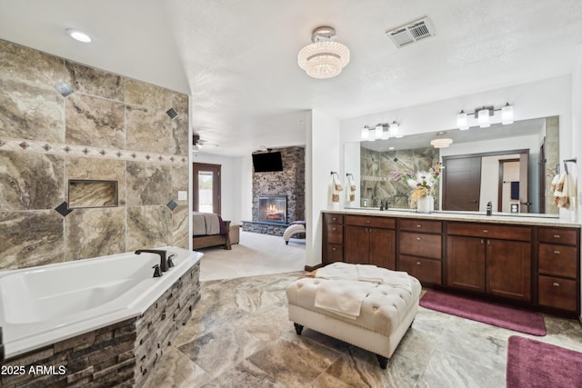 920 N 104th St, Mesa, AZ 85207 - ensuite bathroom with a stone fireplace, double vanity, and a bath