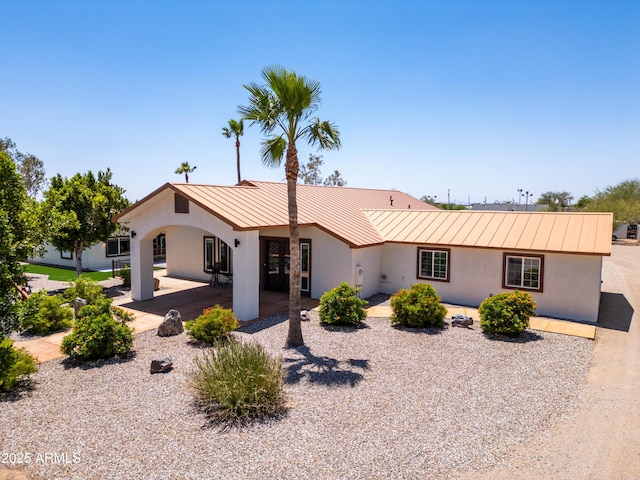 920 N 104th St, Mesa, AZ 85207 - view of front of property featuring a standing seam roof, stucco siding, and metal roof