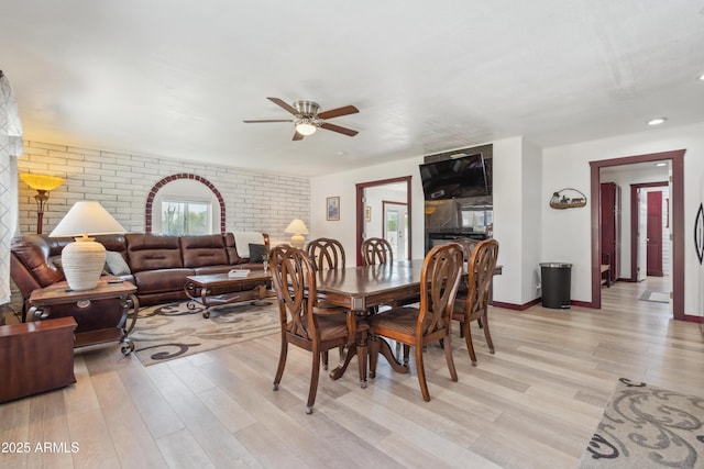 920 N 104th St, Mesa, AZ 85207 - dining space with light wood-type flooring, a ceiling fan, brick wall, and baseboards