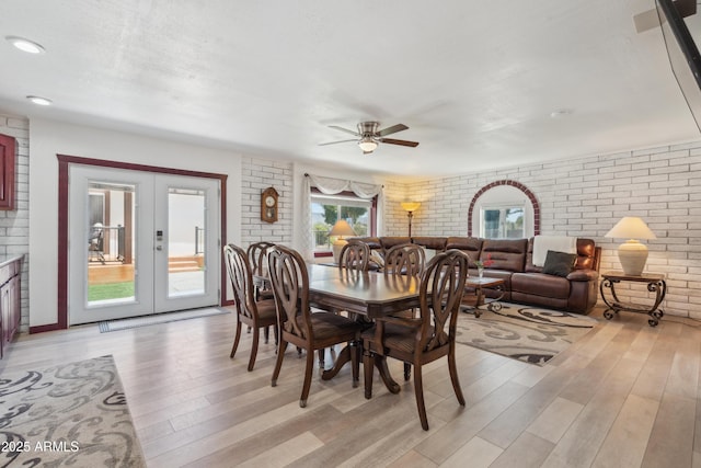 920 N 104th St, Mesa, AZ 85207 - dining space with brick wall, light wood finished floors, a ceiling fan, and french doors