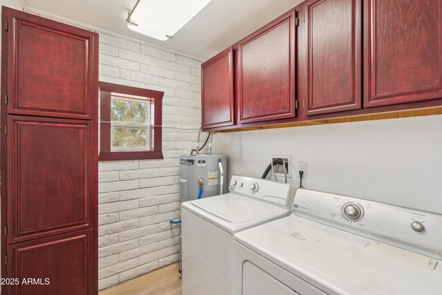 920 N 104th St, Mesa, AZ 85207 - laundry area featuring electric water heater, brick wall, washer and dryer, cabinet space, and light wood-style floors