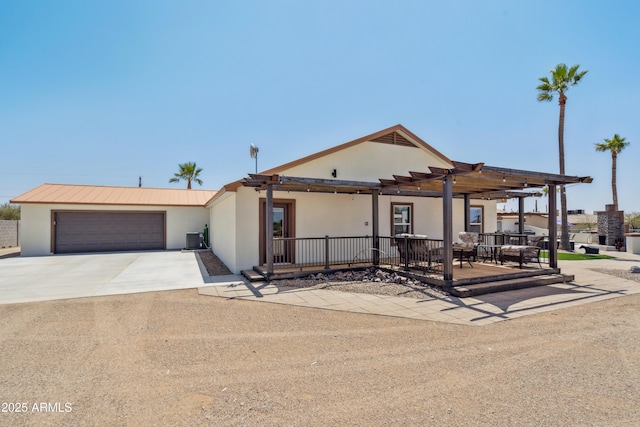 920 N 104th St, Mesa, AZ 85207 - view of front facade with central AC unit, driveway, a pergola, stucco siding, and an attached garage