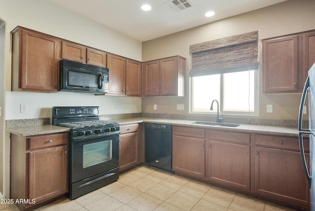 kitchen with light tile patterned floors, recessed lighting, visible vents, a sink, and black appliances