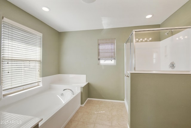 bathroom with recessed lighting, a stall shower, a bath, baseboards, and tile patterned floors