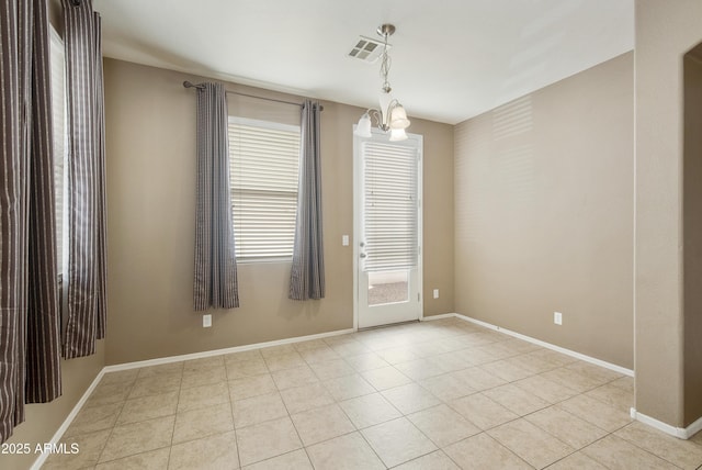 unfurnished room with light tile patterned floors, baseboards, visible vents, and a notable chandelier