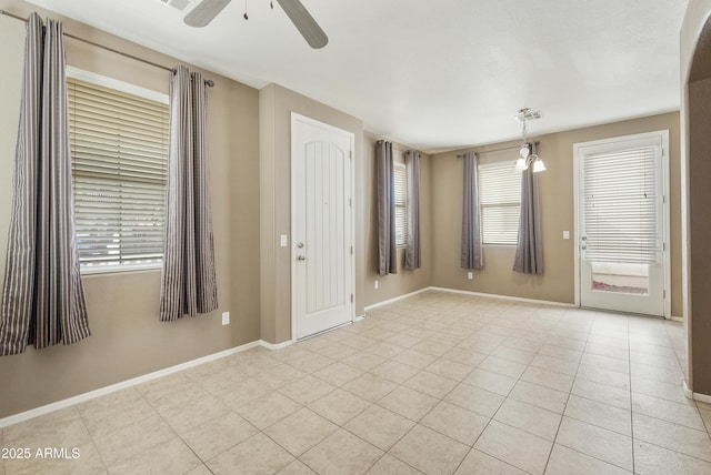 foyer entrance featuring a ceiling fan, light tile patterned flooring, visible vents, and baseboards