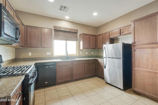 kitchen with recessed lighting, visible vents, light tile patterned flooring, a sink, and black appliances