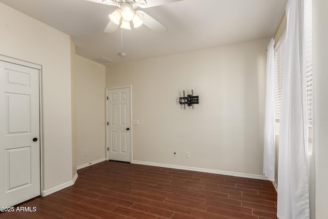 21605 S 187th Way, Queen Creek, AZ 85142 - unfurnished bedroom with dark wood-style flooring, baseboards, and a ceiling fan