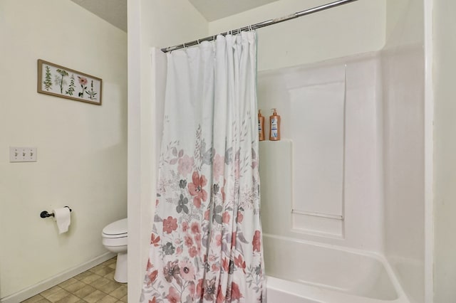 bathroom featuring shower / bathtub combination with curtain and toilet