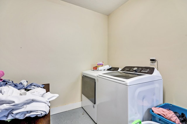 laundry area featuring washer and dryer, baseboards, and laundry area