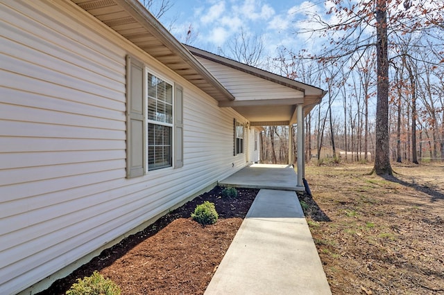 view of exterior entry with a porch