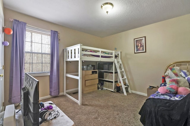 carpeted bedroom with a textured ceiling and baseboards