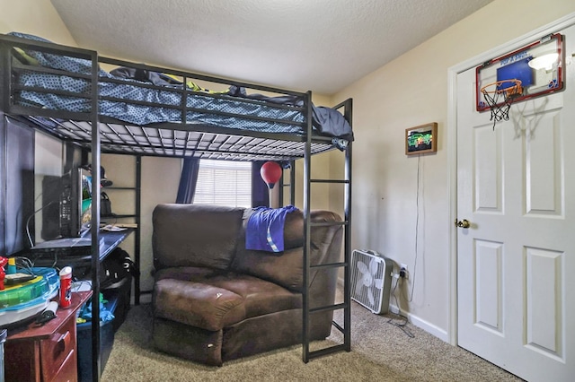 bedroom with baseboards, carpet, and a textured ceiling