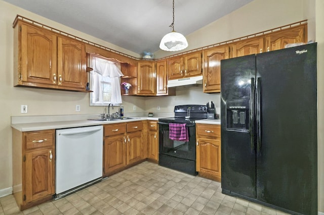 kitchen with under cabinet range hood, light countertops, brown cabinets, black appliances, and a sink