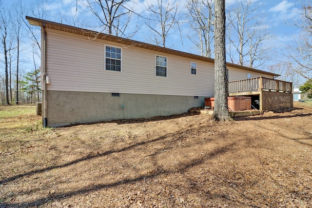 rear view of property featuring crawl space, central AC unit, and a wooden deck