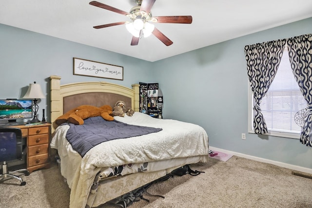 bedroom featuring visible vents, a ceiling fan, baseboards, and carpet floors