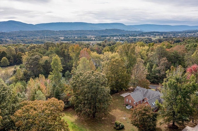 birds eye view of property with a mountain view and a wooded view