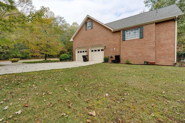 view of side of home with brick siding, a yard, and driveway