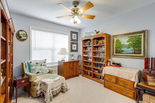 sitting room featuring a ceiling fan and light colored carpet