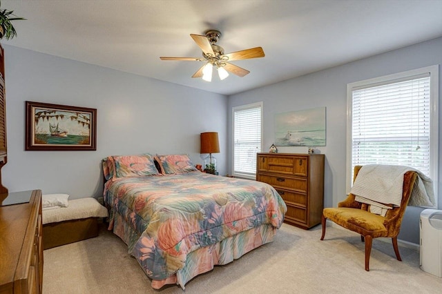 bedroom featuring a ceiling fan and light colored carpet