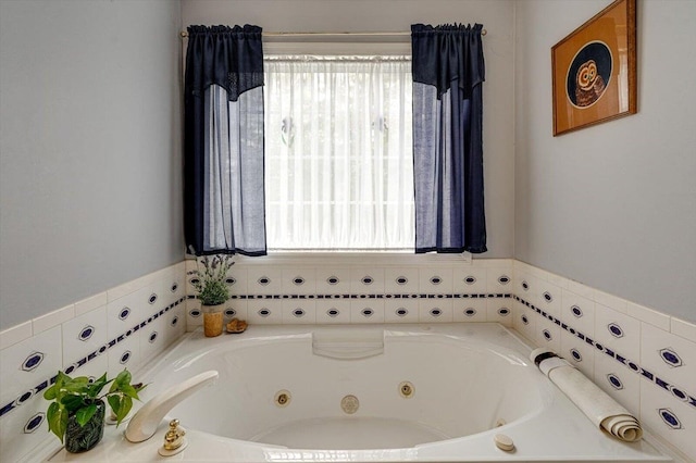 bathroom with a tub with jets