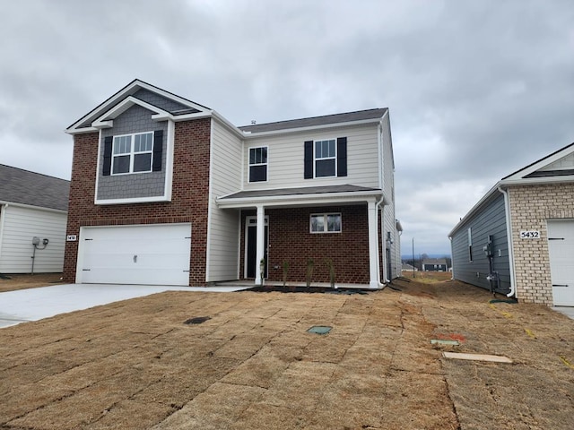 view of front of home with a garage, driveway, and brick siding