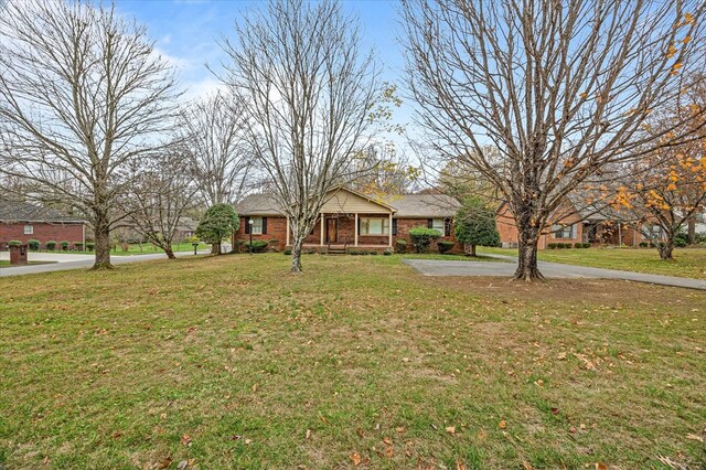 view of front of property with brick siding and a front yard