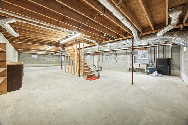 below grade area featuring water heater and stairway