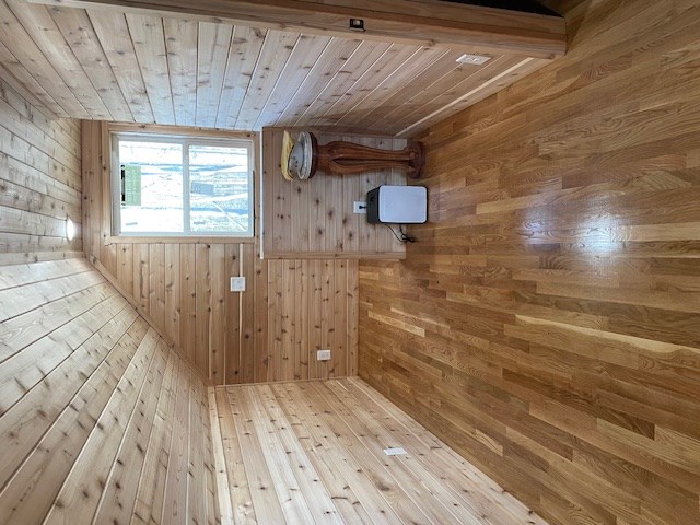 bathroom with wood ceiling, wooden walls, and wood finished floors