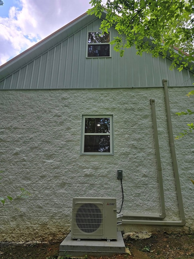 view of side of home featuring ac unit and stucco siding