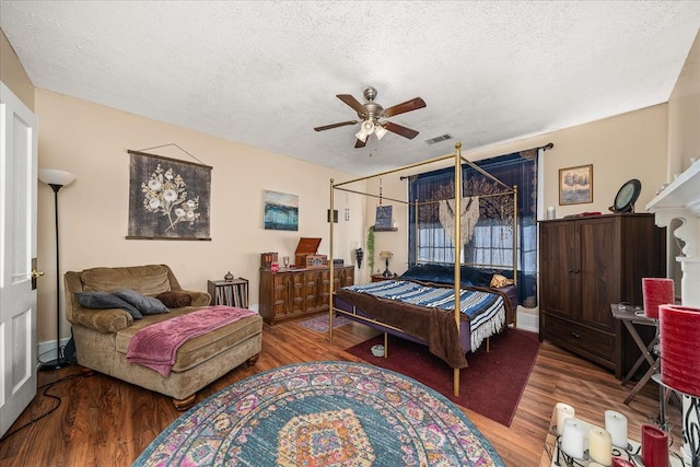 bedroom featuring a textured ceiling, wood finished floors, and visible vents