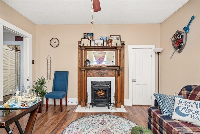 sitting room featuring baseboards and wood finished floors