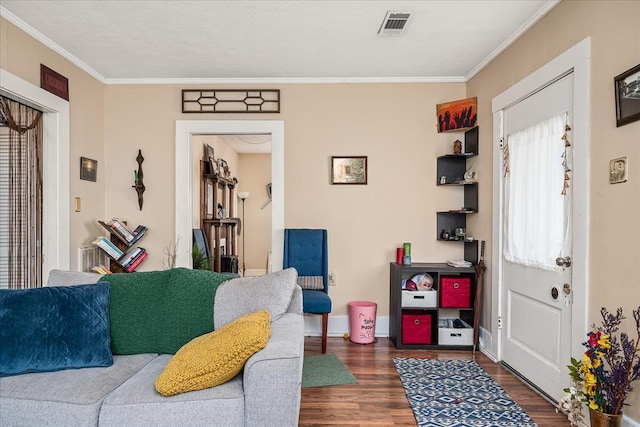 living room featuring ornamental molding, dark wood-style flooring, visible vents, and baseboards